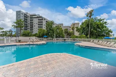 a swimming pool with blue water in a building at Superior Central Condo with Balcony 7 Min to Universal in Orlando