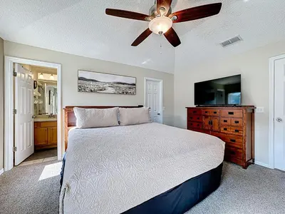 a bedroom with a bed and a ceiling fan at Emerald Island Disney Villa with Pool & Spa in Kissimmee