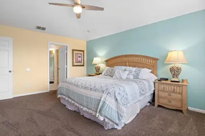 a bedroom with a large bed with blue walls at Windsor Hills Fun 6BR Villa Pool Spa By Disney in Orlando