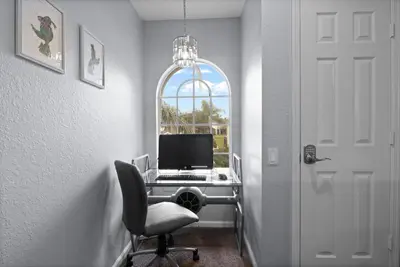 an office with a desk with a computer and a window at Windsor Hills Fun 6BR Villa Pool Spa By Disney in Orlando