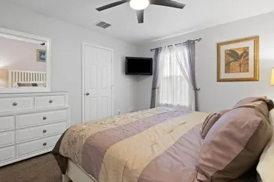 a bedroom with a bed and a ceiling fan at Windsor Hills Fun 6BR Villa Pool Spa By Disney in Orlando