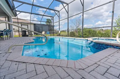 a large swimming pool with blue water at Windsor Hills Fun 6BR Villa Pool Spa By Disney in Orlando