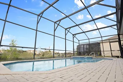 a large swimming pool with a glass roof at Windsor Hills Fun 6BR Villa Pool Spa By Disney in Orlando