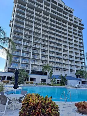 a large building with a pool in front of it at Blue Heron Beach Resort 1-809 in Orlando