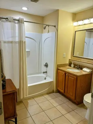 a bathroom with a tub and a toilet and a sink at Blue Heron Beach Resort 1-809 in Orlando