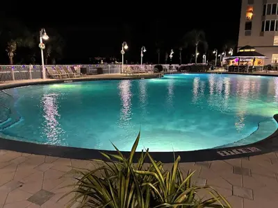 a large swimming pool at night with lights at Blue Heron Beach Resort 1-809 in Orlando