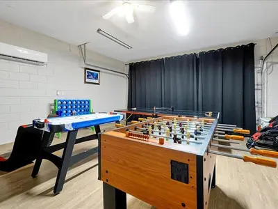 a room with a table and a chess board at Themed Windsor Hills 6BR Private Pool Gameroom in Orlando