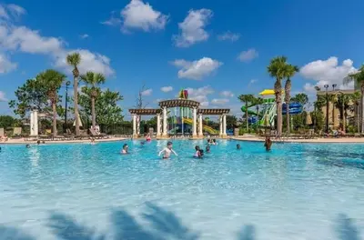a group of people in a swimming pool at a theme park at Themed Windsor Hills 6BR Private Pool Gameroom in Orlando