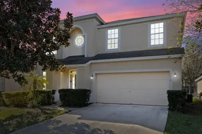 a house with a clock on the top of it at Themed Windsor Hills 6BR Private Pool Gameroom in Orlando