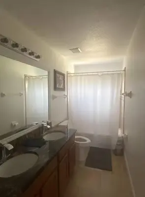 a bathroom with two sinks and a toilet at The Mahal in Sanford