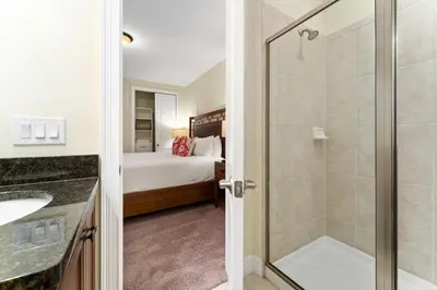 a bathroom with a shower and a bedroom at Amazing Stay 10 min from Disney in Orlando