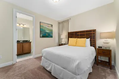 a bedroom with a large white bed with yellow pillows at Amazing Stay 10 min from Disney in Orlando