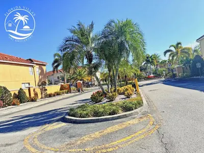 a street with palm trees on the side of a road at Paradise Cay Resort - Close to Disney in Kissimmee