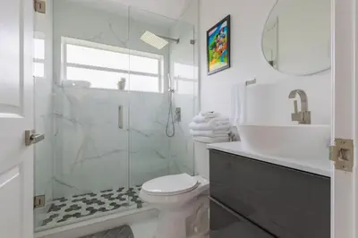 a bathroom with a toilet and a sink and a shower at Resort-Style Home Near Disney | Pool | Game Room in Kissimmee