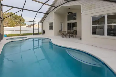 a swimming pool in a house with a glass ceiling at Resort-Style Home Near Disney | Pool | Game Room in Kissimmee