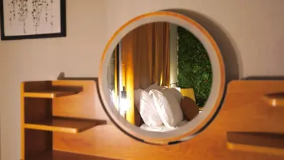 a bedroom with a mirror on a table at Quiet Boho Suite near Orlando attractions in Orlando