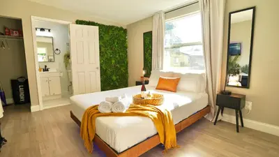 a bedroom with a bed with towels on it at Quiet Boho Suite near Orlando attractions in Orlando