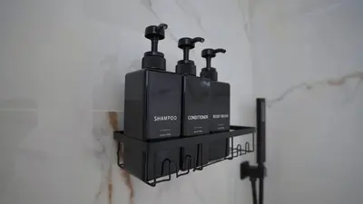a wall mounted soap dispenser on a bathroom wall at Quiet Boho Suite near Orlando attractions in Orlando