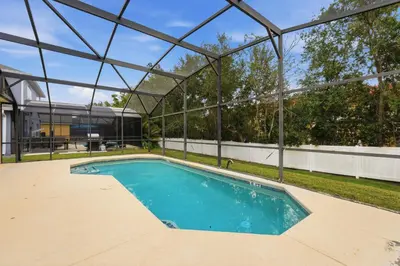 a swimming pool in a house with a glass roof at The Seasons Retreat 5BR Oasis with Private Pool in Kissimmee