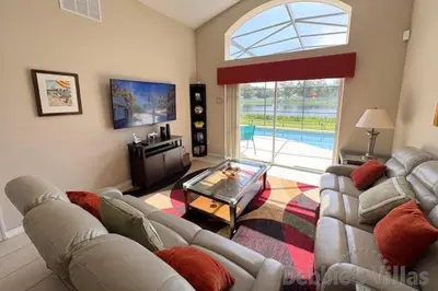 a living room with a couch and a glass table at Seasons Kissimmee in Kissimmee