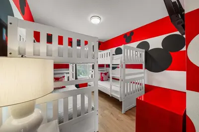 a red and white room with two white bunk beds at 8564 Bay Lilly Loop in Kissimmee