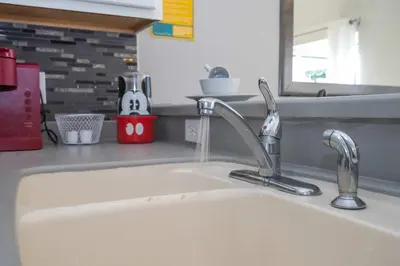 a kitchen counter with a sink and a sink at Stylish 4BR Townhome Private Pool BBQ & Near Disney in Kissimmee