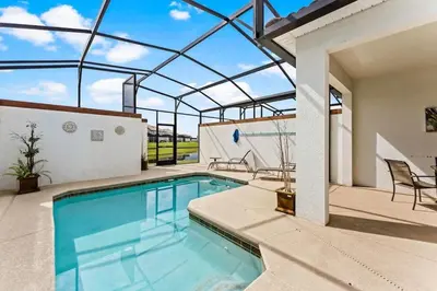 a swimming pool with a glass roof on a house at Casa 4Q Storey Lake - Piscina Privativa in Kissimmee