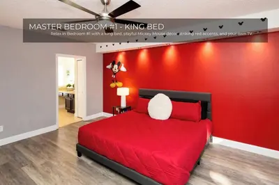 a red bedroom with a bed with a red wall at 5BRDisney Villa Pool,Game Room & Resort Access in Kissimmee