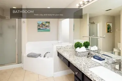 a bathroom with a sink and a tub and a toilet at 5BRDisney Villa Pool,Game Room & Resort Access in Kissimmee