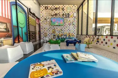 a room with a blue table with books on it at 4BR Disney Area Townhome - Pool, Grill & Clubhouse in Orlando