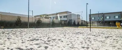 an empty volleyball court with a volley ball hoop at 4BR Disney Area Townhome - Pool, Grill & Clubhouse in Orlando