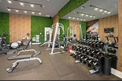 a gym with several treadmills and exercise machines at 4BR Disney Area Townhome - Pool, Grill & Clubhouse in Orlando