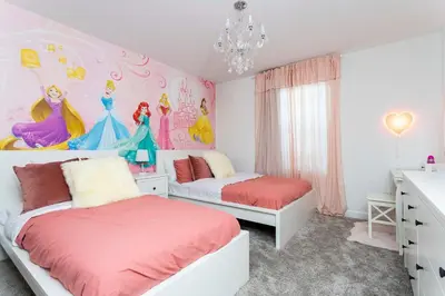 a bedroom with two beds and a disney princess mural at Townhome 4Q Storey Lake - Piscina & Temas in Kissimmee