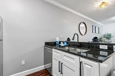 a kitchen with a sink and a mirror at Near Disney! Kissimmee Home for 12 w/ Pool Access! in Kissimmee
