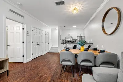 a dining room with a table and chairs and a kitchen at Near Disney! Kissimmee Home for 12 w/ Pool Access! in Kissimmee