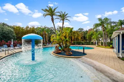 a pool at a resort with a fountain at Near Disney! Kissimmee Home for 12 w/ Pool Access! in Kissimmee