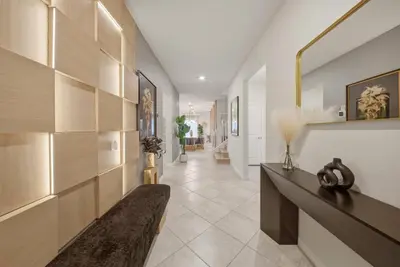 a living room with a couch and a hallway at Brand NEW 10Bdrms8Bath Luxury in Orlando