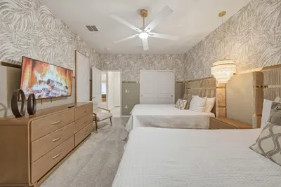 a bedroom with two beds and a flat screen tv at Brand NEW 10Bdrms8Bath Luxury in Orlando
