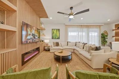 a living room with a couch and a tv at Brand NEW 10Bdrms8Bath Luxury in Orlando