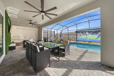a dining room with a table and a pool at Brand NEW 10Bdrms8Bath Luxury in Orlando