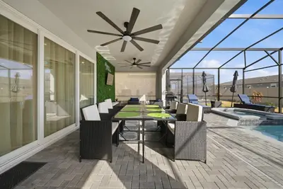 a dining room with a table and chairs and a pool at Brand NEW 10Bdrms8Bath Luxury in Orlando