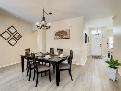 a dining room with a black table and chairs at Holiday Home Familien-Pool-Rückzug nur 2-5 Meilen von Disney entfernt by Interhome in Kissimmee
