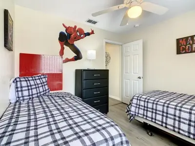 a bedroom with two beds and a juggler on the wall at Holiday Home Familien-Pool-Rückzug nur 2-5 Meilen von Disney entfernt by Interhome in Kissimmee