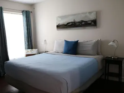 a bedroom with a large bed with blue and white pillows at Apartment Orlando Condo in der Nähe von Disney- Schläft 8 by Interhome in Kissimmee