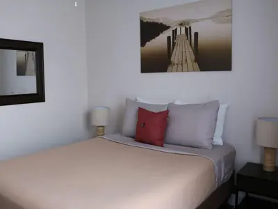 a bedroom with a white bed with a red pillow at Apartment Orlando Condo in der Nähe von Disney- Schläft 8 by Interhome in Kissimmee