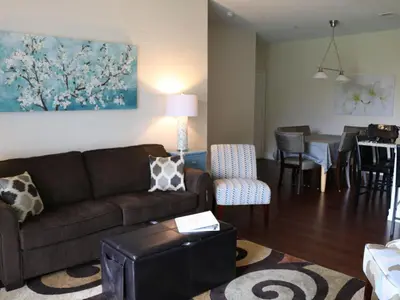 a living room with a couch and a dining room at Apartment Orlando Condo in der Nähe von Disney- Schläft 8 by Interhome in Kissimmee