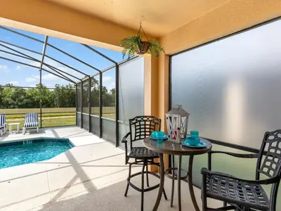 a patio with a table and chairs next to a pool at Holiday Home Ferienvilla Magical Memories by Interhome in Kissimmee