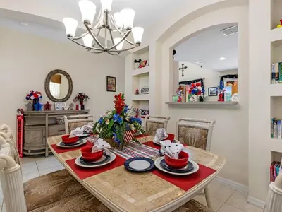 a dining room with a table and a christmas tree at Holiday Home Ferienvilla Magical Memories by Interhome in Kissimmee