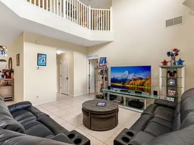 a living room with couches and a flat screen tv at Holiday Home Ferienvilla Magical Memories by Interhome in Kissimmee