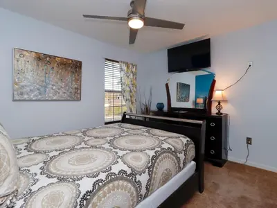 a bedroom with a bed and a flat screen tv at Holiday Home Villa mit 6 Schlafzimmern und atemberaubendem Seeblick by Interhome in Kissimmee